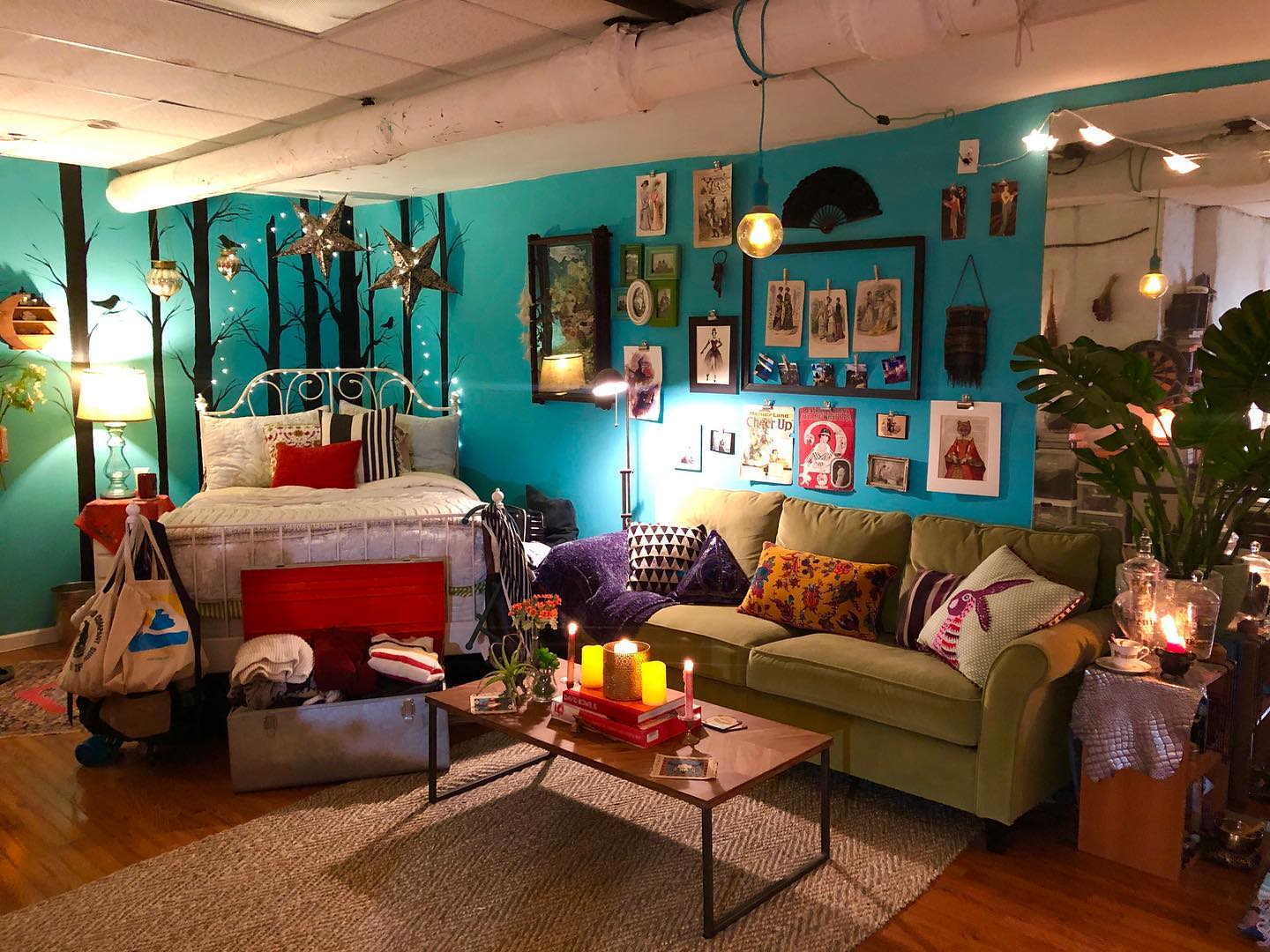 Eccentric living room with vibrant decor, teal walls, fairy lights, and eclectic wall art.